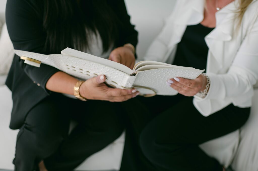 two people looking together at a book